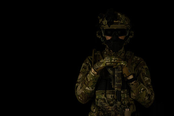 SOF special forces soldier wearing US made gear, crye precision, ops core. Studio portrait  isolated on black background 