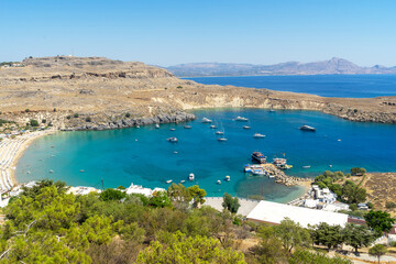 Fototapeta na wymiar Beach of Lindos on the island of Rhodes, in the Dodecanese, Greece. Bay in the shape of a heart