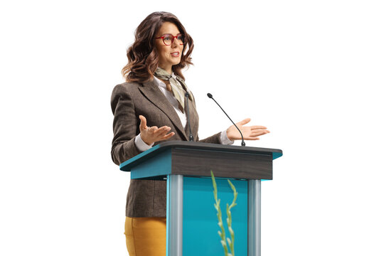 Young woman speaker on a pedestal gesturing with hands