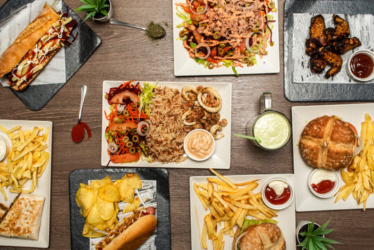 Set of fast food dishes, sandwiches and burgers, french fries, barbecue wings, basmati rice, salad with variants, Mexican burrito and hot dog