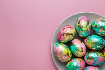 Minimalistic Easter composition. Golden paint eggs on pink background. Greeting trendy color concept. Top view, copy space.