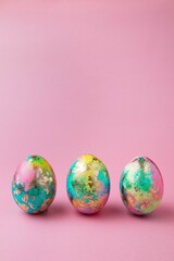 Easter colorful eggs on pink background. Easter card. Copy space for text. Selective focus.