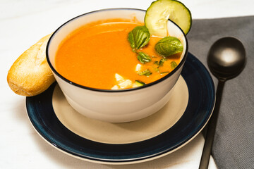 Modern white bowl with Andalusian Gazpacho. Vegetable and organic soup or cold drink that is drunk in summer. high view