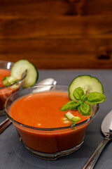 Transparent glass bowl with Gaspacho Andaluz. A vegetable and organic soup or cold drink that is drunk in summer or hot days. Copy space.