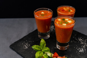 Small glasses of shot or liqueur with the exquisite Andalusian Gazpacho. A cold vegetable and organic soup or drink that is drunk in summer or hot days.