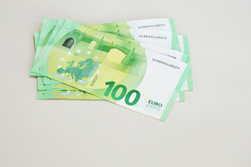 Banknotes of 100 euros on a light background. Banknotes, money, European Union currency. Bank transactions.