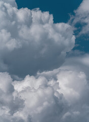 Fluffy white clouds in a blue sky. Heavenly background.