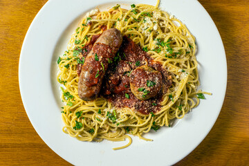 speghetti top sauce parsley and parmesan cheese