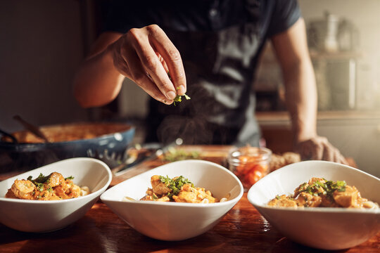 Food As Good As The Restaurant Makes It. Shot Of An Unrecognisable Man Preparing A Delicious Meal At Home.