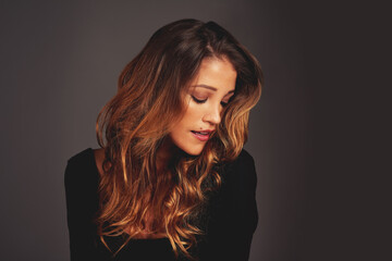 Fototapeta premium Gorgeous hair is the best revenge. Studio shot of a beautiful woman with long locks posing against a grey background.