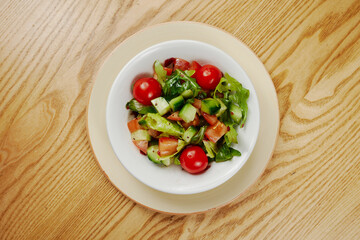 Light vegetable salad with cucumbers, lettuce, cucumbers