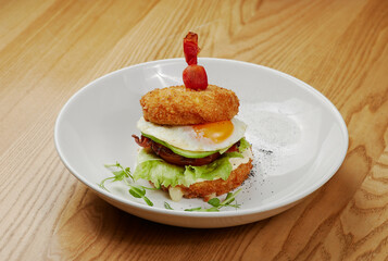 fried sandwich with bacon, vegetables and meat