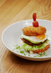 fried sandwich with bacon, vegetables and meat