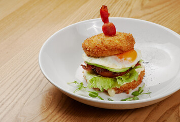 fried sandwich with bacon, vegetables and meat