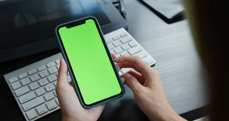Woman use of cellphone with green screen