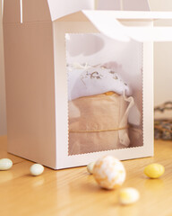 Easter cake decorated with icing, candied fruit, lavender and chocolate in a gift box.