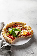 Summer puff pastry quishe with tomato, mozzarella and Bazil. Text space