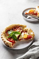 Summer puff pastry quishe with tomato, mozzarella and Bazil. Text space