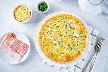 Bacon quiche with cheese and scallions in a plate