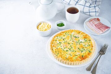 Bacon quiche with cheese and scallions in a plate