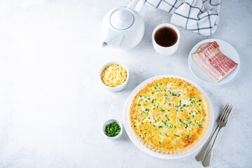 Bacon quiche with cheese and scallions in a plate