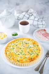 Bacon quiche with cheese and scallions in a plate