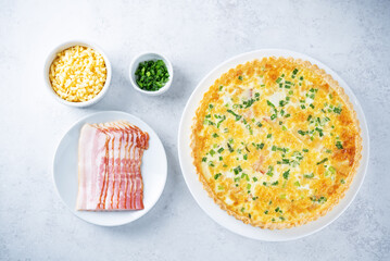 Bacon quiche with cheese and scallions in a plate