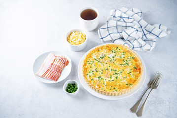 Bacon quiche with cheese and scallions in a plate