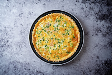 Bacon quiche with cheese and scallions in a plate