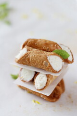Sicilian cannoli with ricotta, traditional Sicilian / Italian cakes, minimalist composition on a white background.