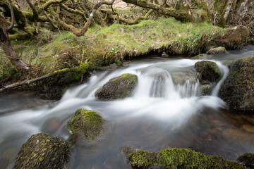 Long exposure of a waterfall on the Weir Water river at Robbers Bridge in Exmoor National Park