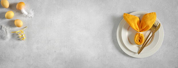 Beautiful festive Easter plates and yellow napkin Bunny, eggs decorate, top view bunner, copy space