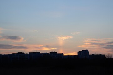 Fototapeta premium Beautiful sunset over the city. Pillar of sunlight. Soft focus. Blur. Background.