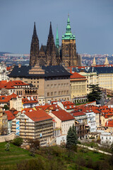 Obraz premium Spring Prague City with gothic Castle and the colorful Nature with flowering Trees from the Hill Petrin, Czech Republic