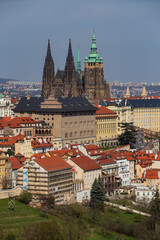 Obraz premium Spring Prague City with gothic Castle and the colorful Nature with flowering Trees from the Hill Petrin, Czech Republic
