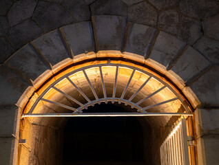 Illuminated entrance to a tunnel in the city walls in Menton, France