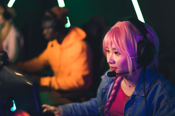 pink-haired girl playing video games and streaming eSport tournament medium closeup indoors neon...