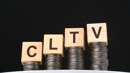 on a black background are coins and wooden cubes with the inscription - cltv