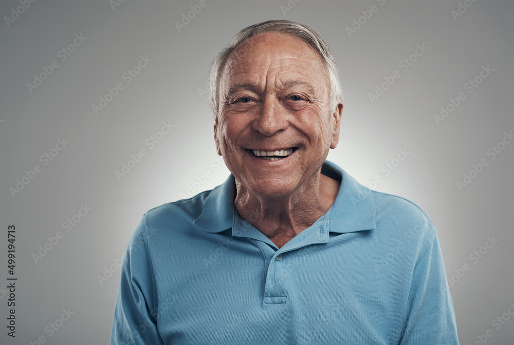 Sticker I feel like Im on cloud 9 today. Shot of a man happily smiling at the camera in a studio against a grey background.