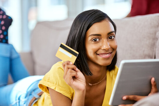 Mom Said I Could Go Shopping With Her Card. Shot Of A Teenage Girl Using A Tablet And Credit Card At Home.