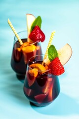 Spanish summer cocktail Sangria served in glasses decorated with fresh fruits