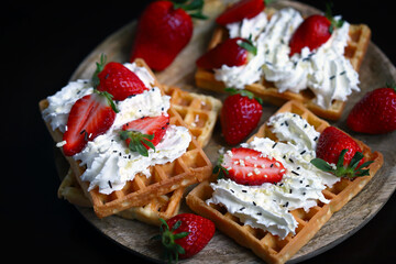 Belgian waffles with strawberries and cream.