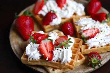 Belgian waffles with strawberries and cream.