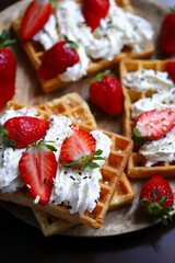 Belgian waffles with strawberries and cream.