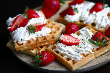Belgian waffles with strawberries and cream.