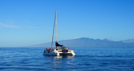 Catamaran sailboat in the Pacific Ocean between Maui and Lanai islands on the Hawaiian archipelago...