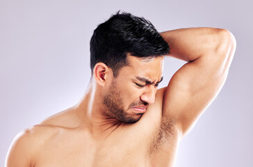 Naklejka premium Im going to need something a little stronger. Studio shot of a man frowning while smelling his armpit.