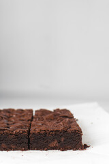 Dark chocolate brownies with caramel on parchment paper