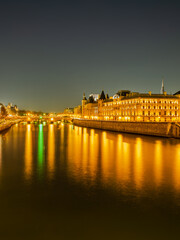 Fototapeta na wymiar Seine river and the Louvre Castle illumiated at night