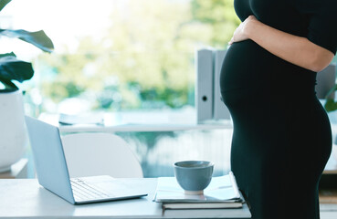 Ill be so busy when the baby comes. Closeup shot of a pregnant businesswoman working in an office.